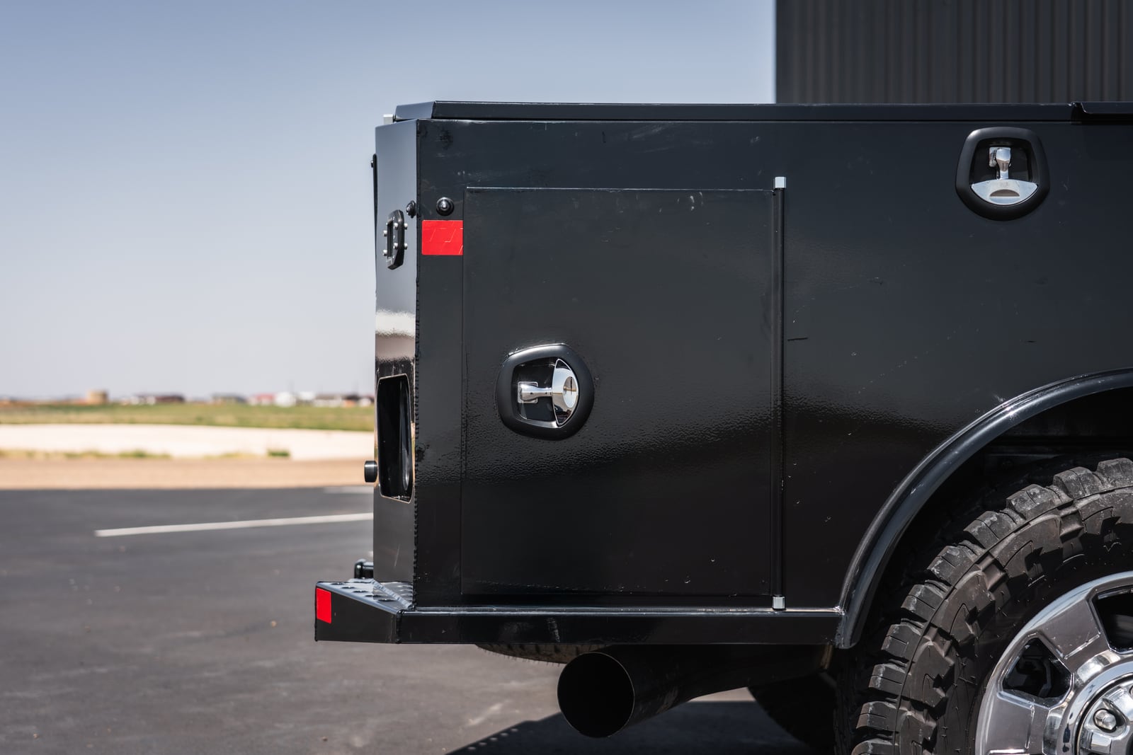 Close side view of an Apollo service-body compartment and compression latches.
