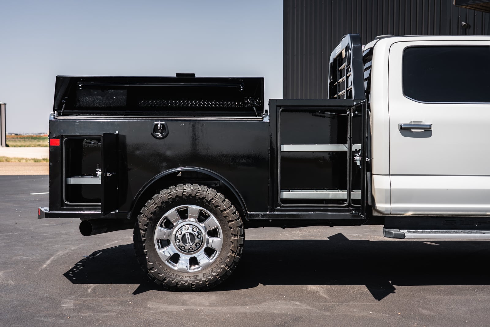 Open Apollo service-body toolboxes showing upper, front, and rear storage compartments.