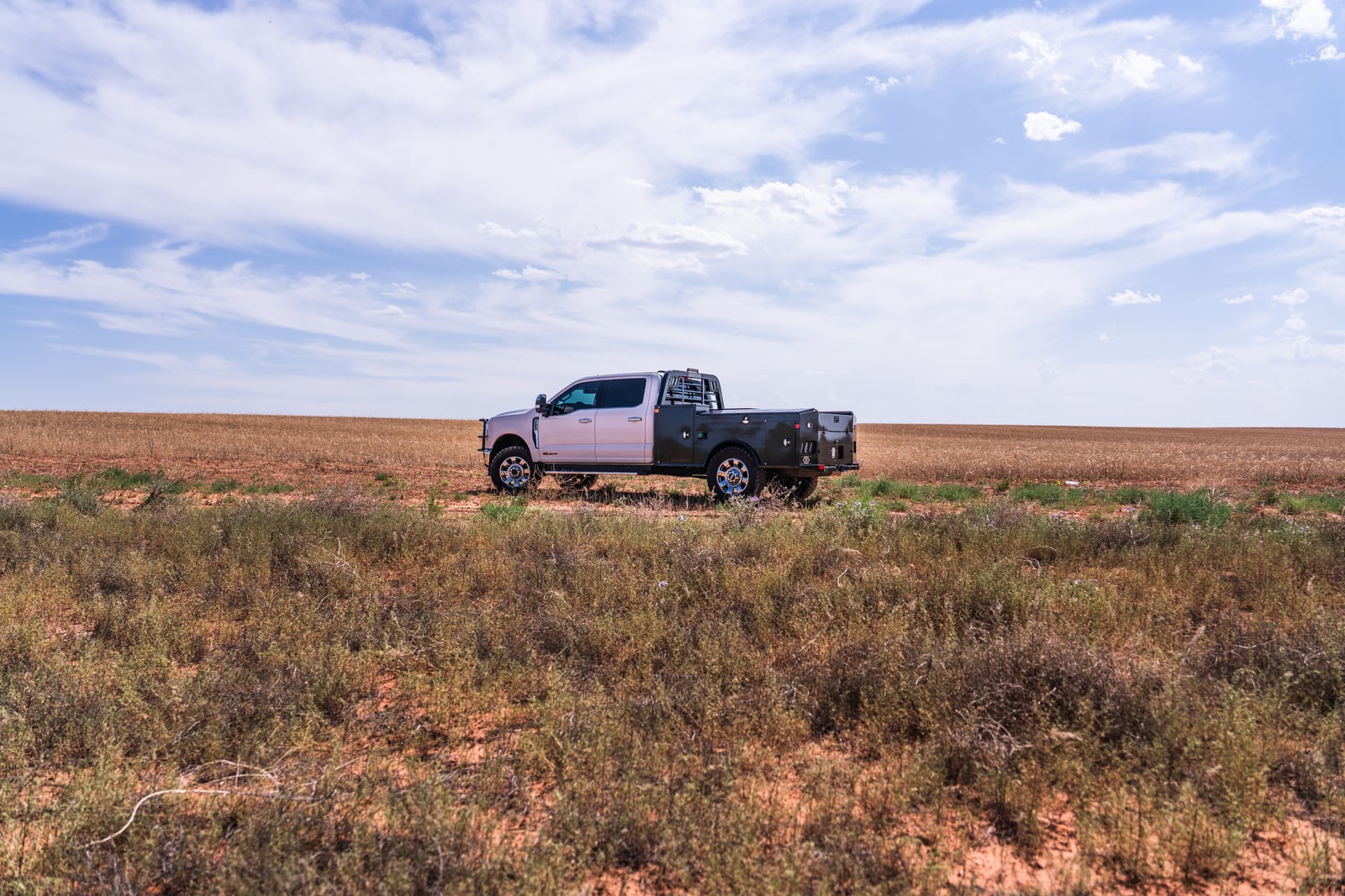 Wide side view of a black Legend X Apollo service body in an open West Texas field.