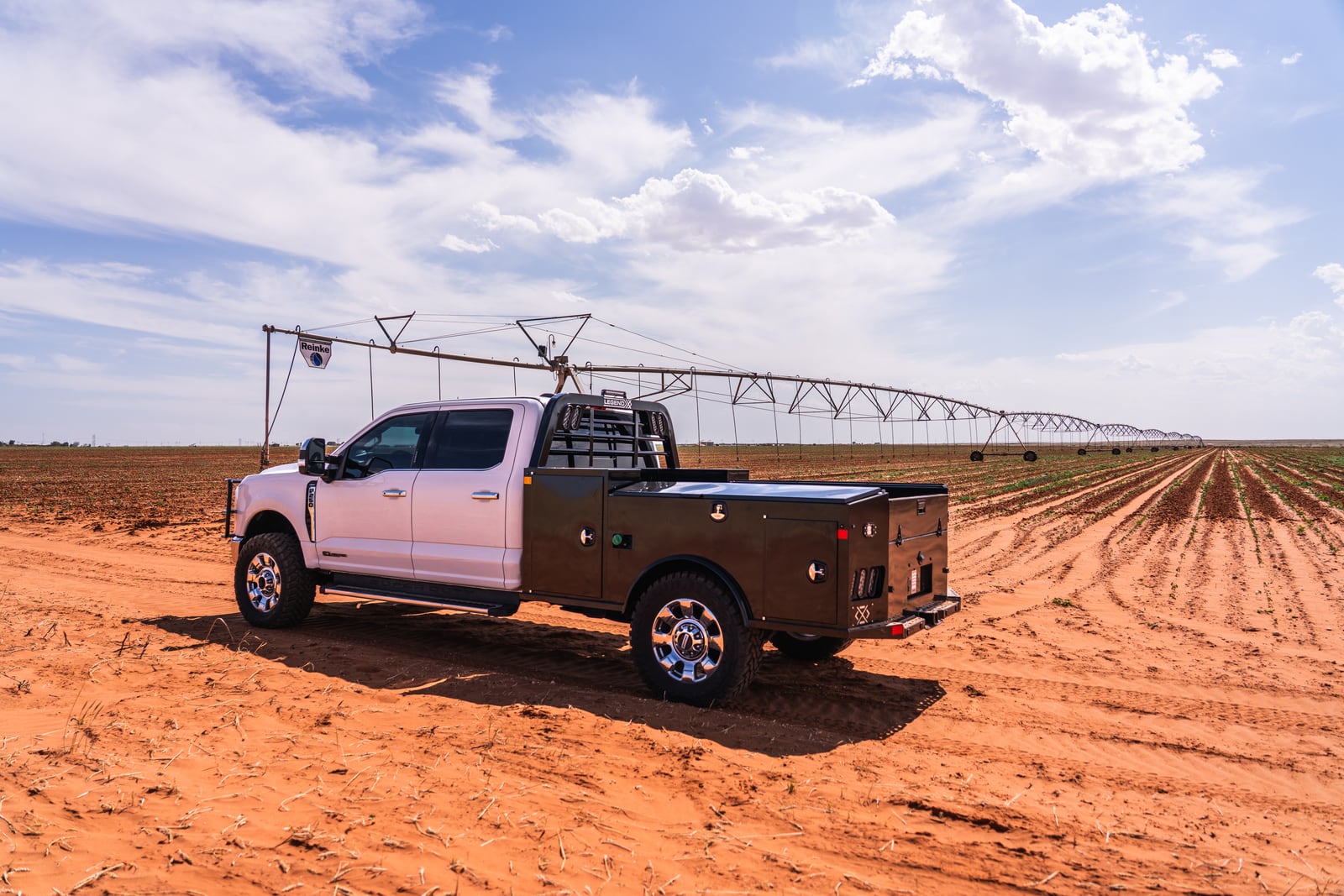 Legend X Apollo service body on a white pickup in an irrigated West Texas field.