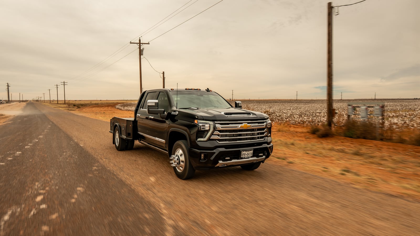 Black Chevrolet dually with a black Legend X Phoenix bed viewed from the front quarter.