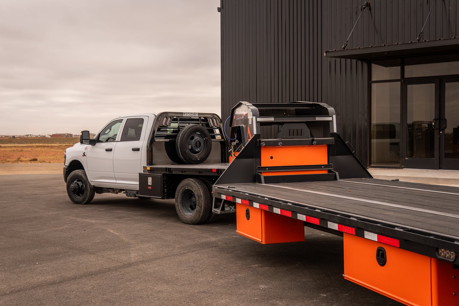 Legend X Spartan flatbed connected to a long gooseneck trailer.