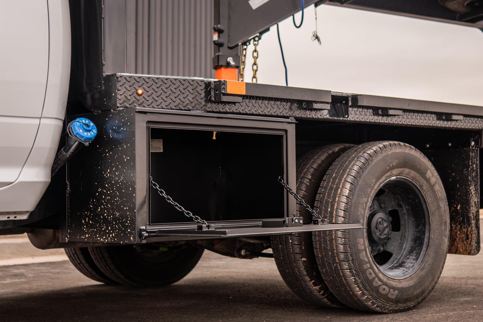 Open side toolbox on a black Legend X Spartan flatbed.