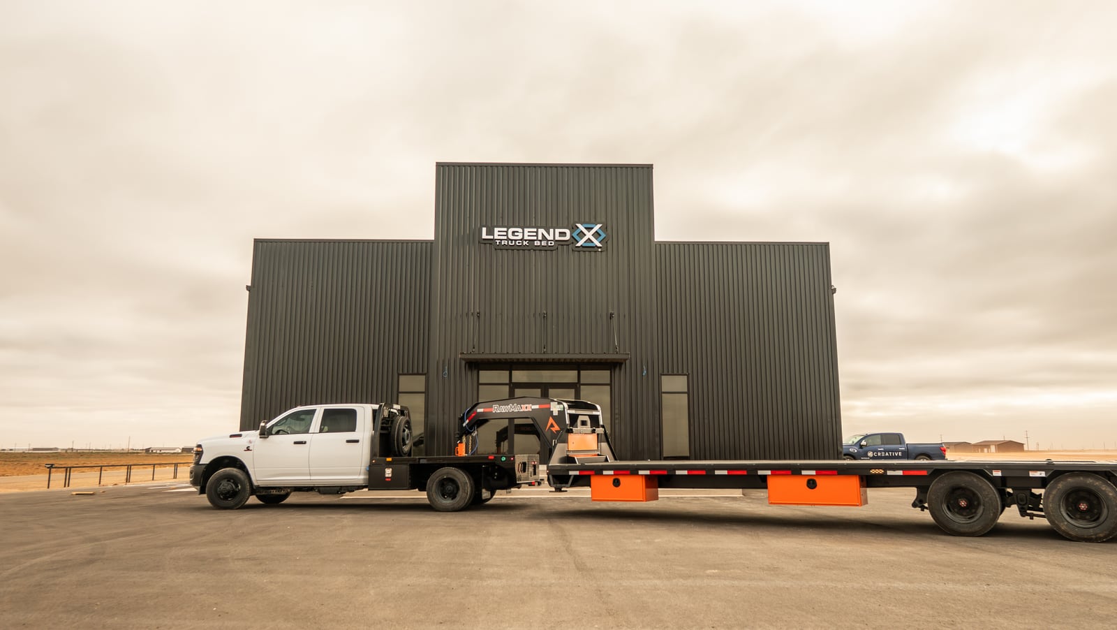Wide view of a Legend X Spartan truck and gooseneck trailer at headquarters.