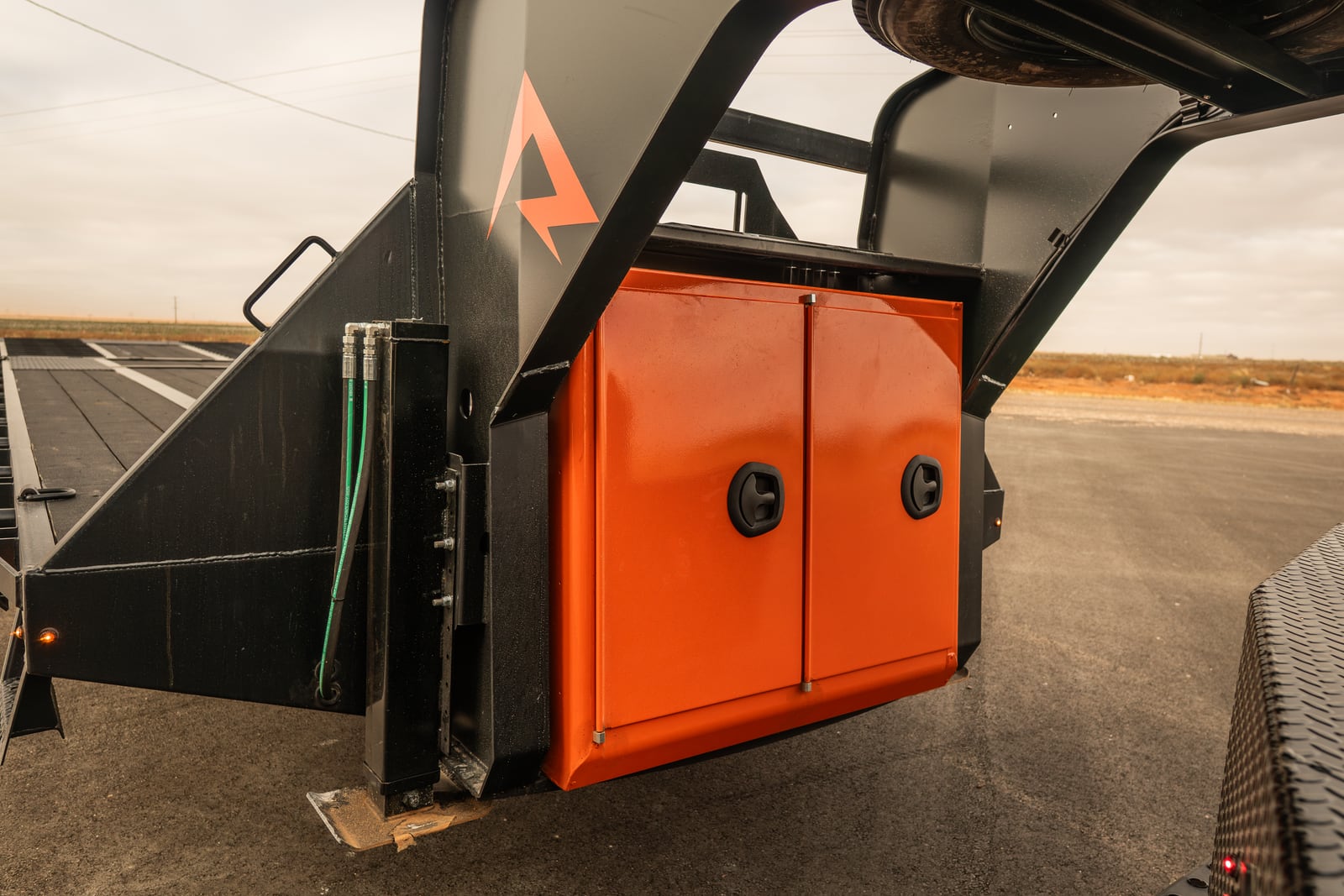 Open orange underbody storage boxes on a Legend X Spartan flatbed.