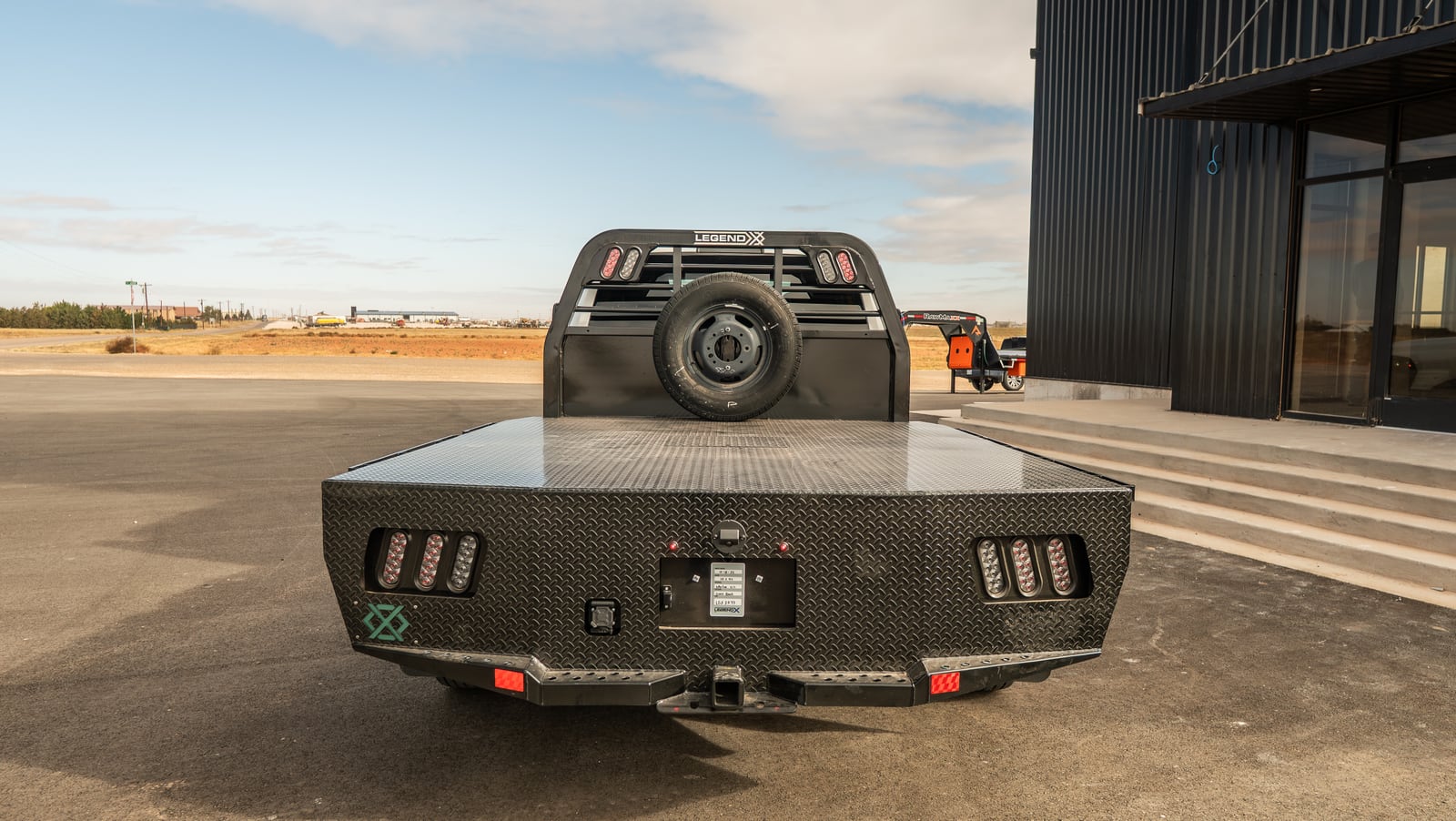 Low rear view of the black Legend X Spartan bed and tailboard.