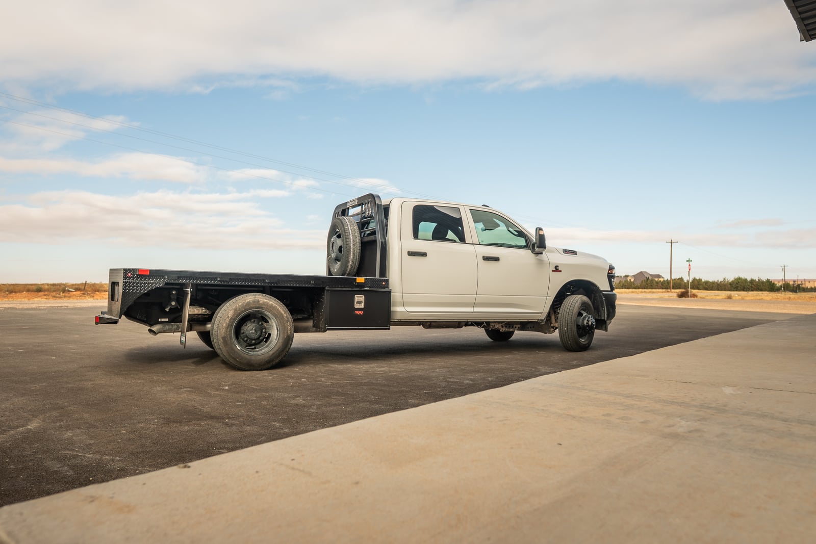 Side rails, stake pockets, and rear structure on a black Legend X Spartan flatbed.