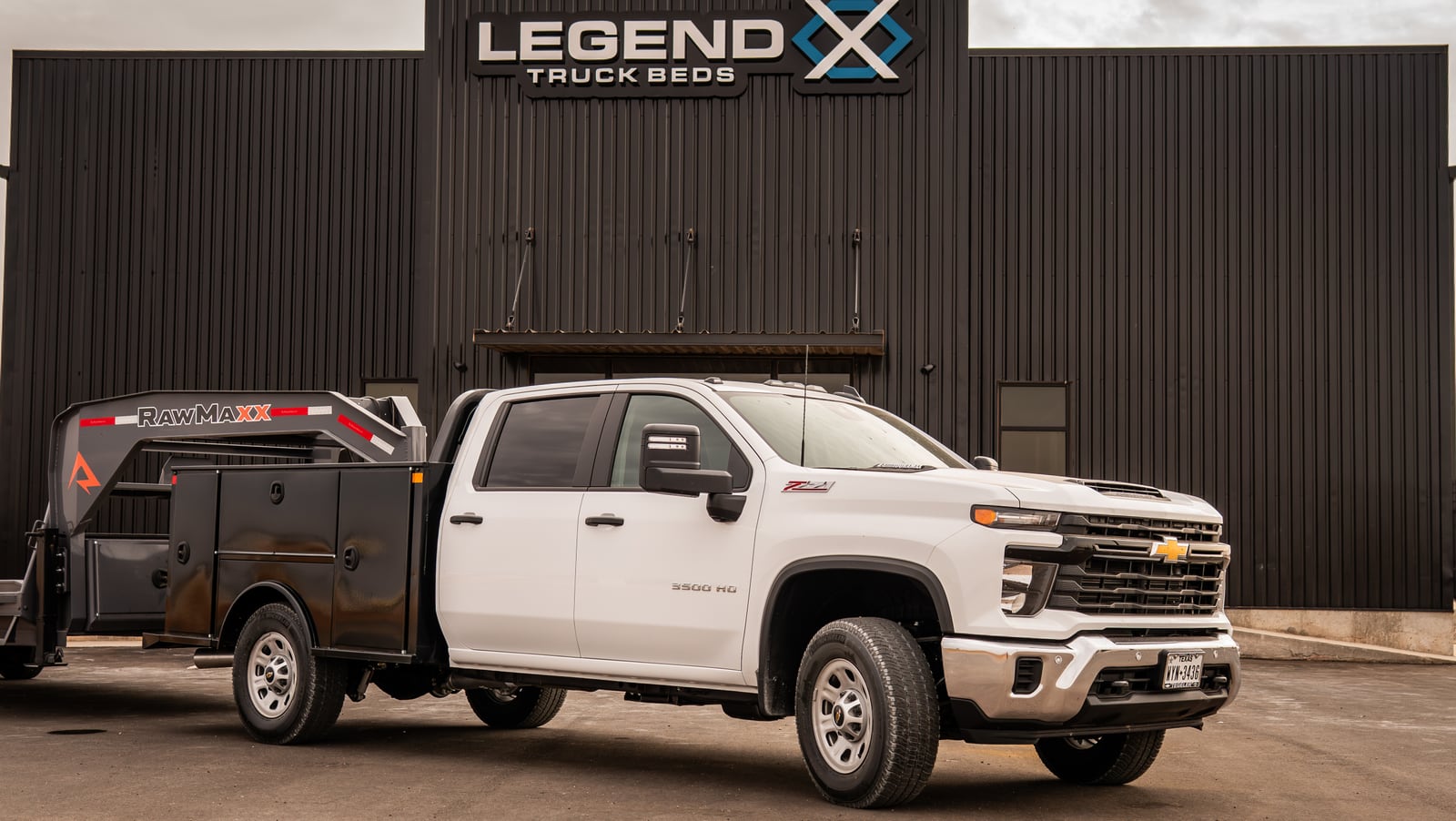 White pickup with a black Legend X Titan service body at headquarters.