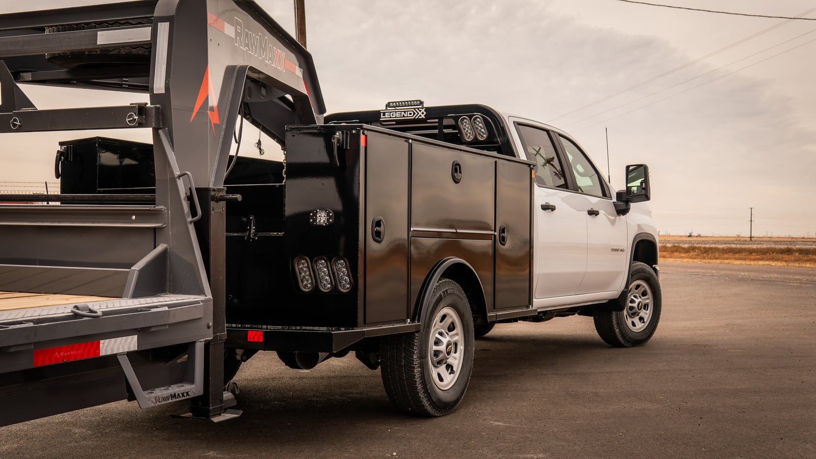 Complete side view of a black Legend X Titan service body on a white pickup.