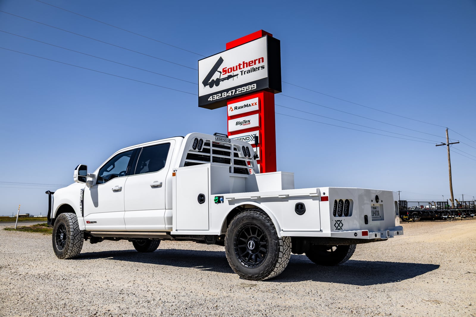 White Legend X Viking Pro work truck outside a trailer dealership.