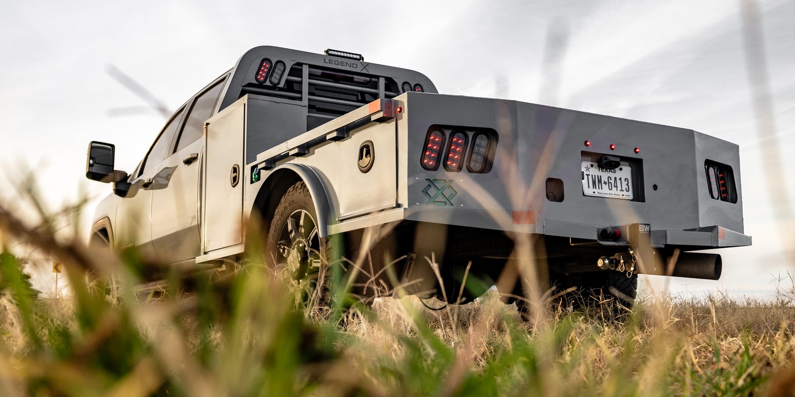 Low rear view of a gray Legend X Viking Pro bed in a grassy field.