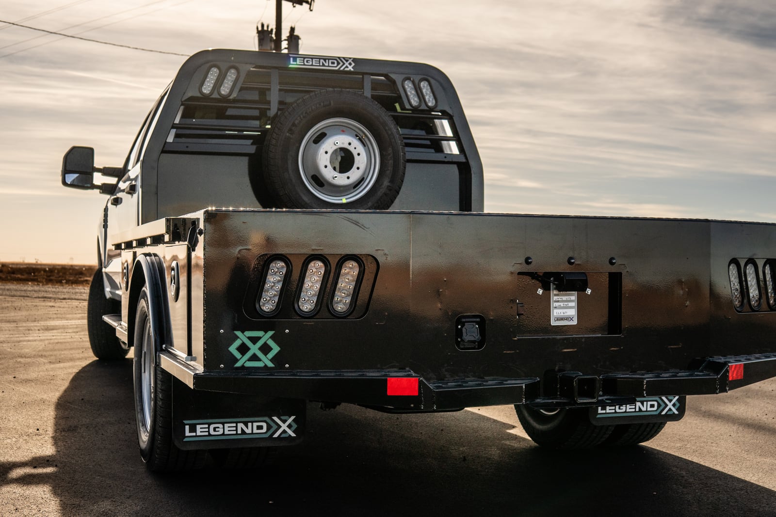 Straight rear view of a black Legend X Viking flatbed.